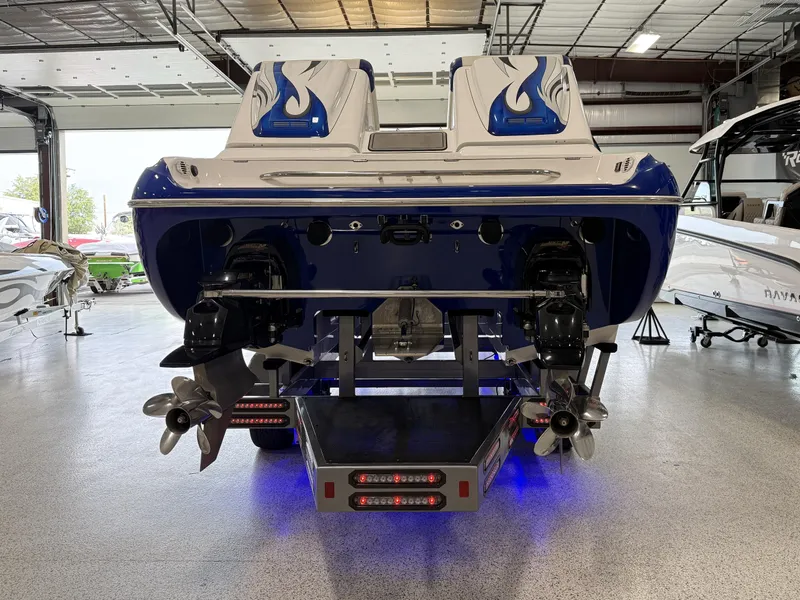 Slide: The Image of 2008 Magic 30' Sceptor boat, rear view, dual engines, blue and white design, indoor showroom. - 10