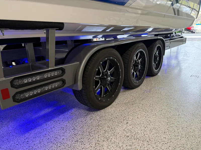 Slide: The Image of 2008 Magic 30' Sceptor boat trailer with triple axles and blue LED lighting. - 12