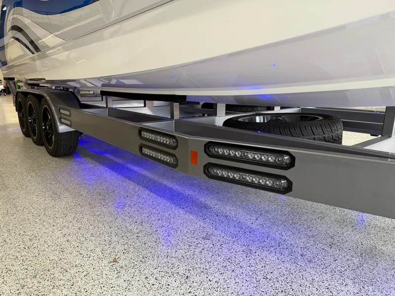 Slide: The Image of 2008 Magic 30' Sceptor boat trailer with blue LED lights and triple axle design. - 13