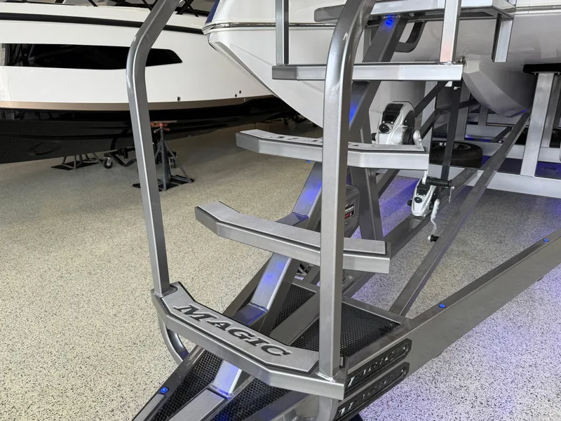 Slide: The Image of Staircase of 2008 Magic 30' Sceptor boat in showroom, featuring sleek metal design. - 15