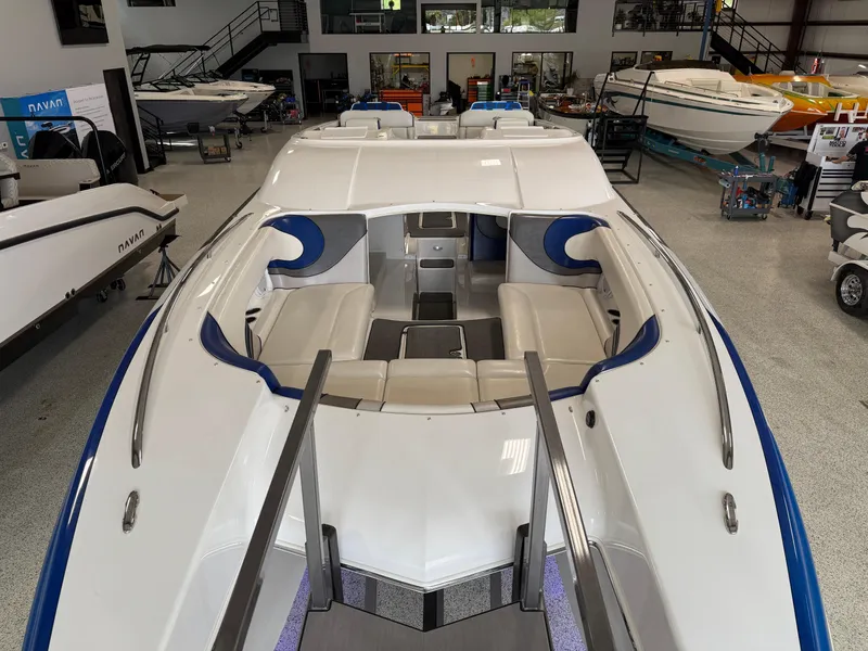Slide: The Image of 2008 Magic 30' Sceptor boat interior with white and blue seating in showroom. - 18