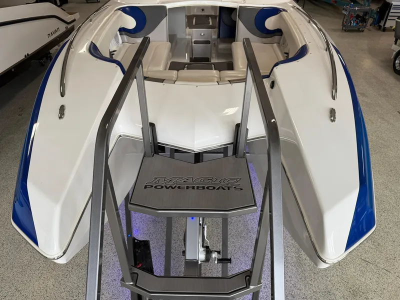 Slide: The Image of 2008 Magic 30' Sceptor powerboat with sleek white and blue design in a showroom. - 19