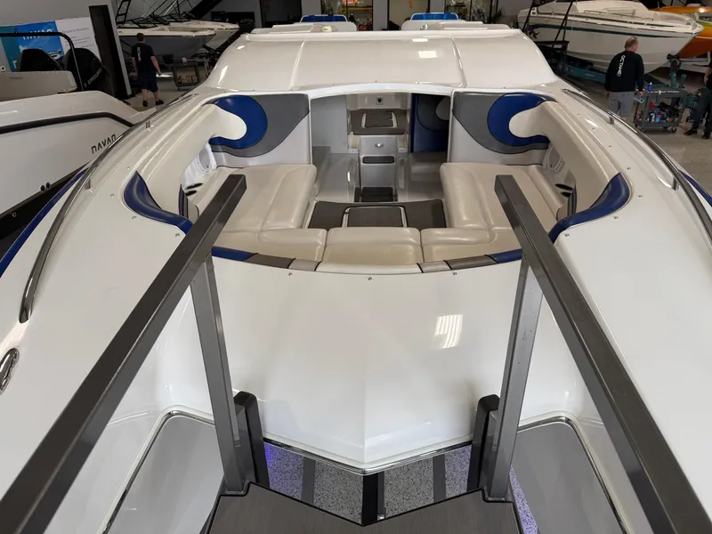Slide: The Image of 2008 Magic 30' Sceptor boat interior with white and blue seating in a showroom. - 20