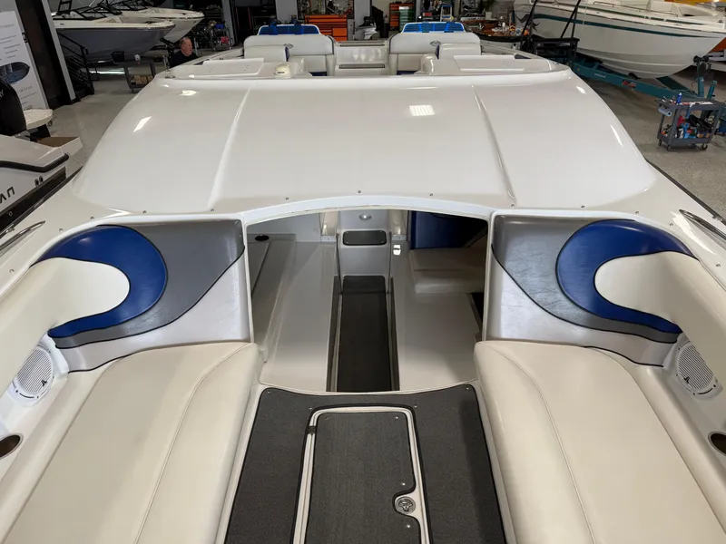Slide: The Image of 2008 Magic 30' Sceptor boat interior with white and blue seating in a showroom. - 21