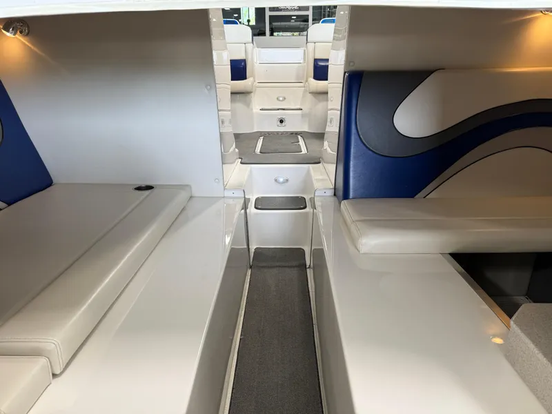 Slide: The Image of Interior of a 2008 Magic 30' Sceptor boat with blue and white seating. - 22