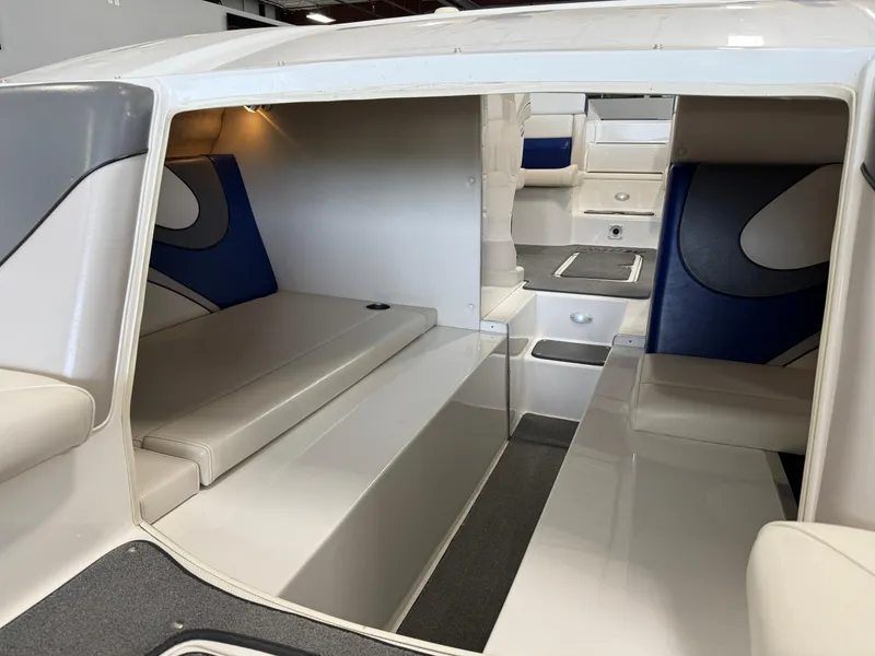Slide: The Image of Interior of a 2008 Magic 30' Sceptor boat, featuring seating and storage areas. - 23