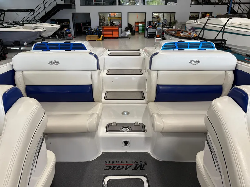 Slide: The Image of Interior of a 2008 Magic 30' Sceptor boat with white and blue seating. - 29