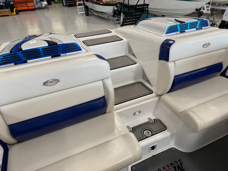 Slide: The Image of 2008 Magic 30' Sceptor boat interior with white and blue seating, showcasing sleek design. - 31