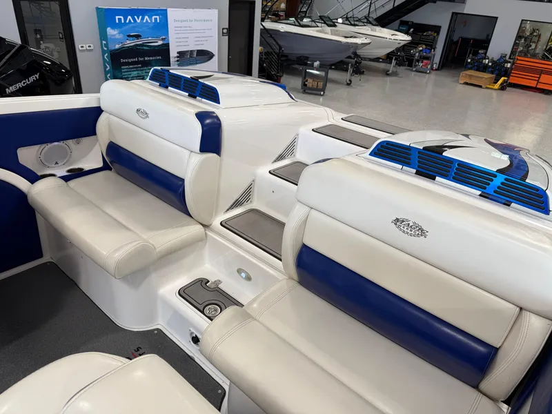 Slide: The Image of 2008 Magic 30' Sceptor boat interior with blue and white seating in showroom. - 32