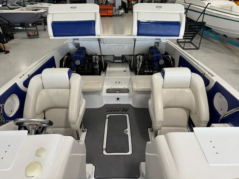 Slide: The Image of 2008 Magic 30' Sceptor boat interior with white seating and dual engines. - 33