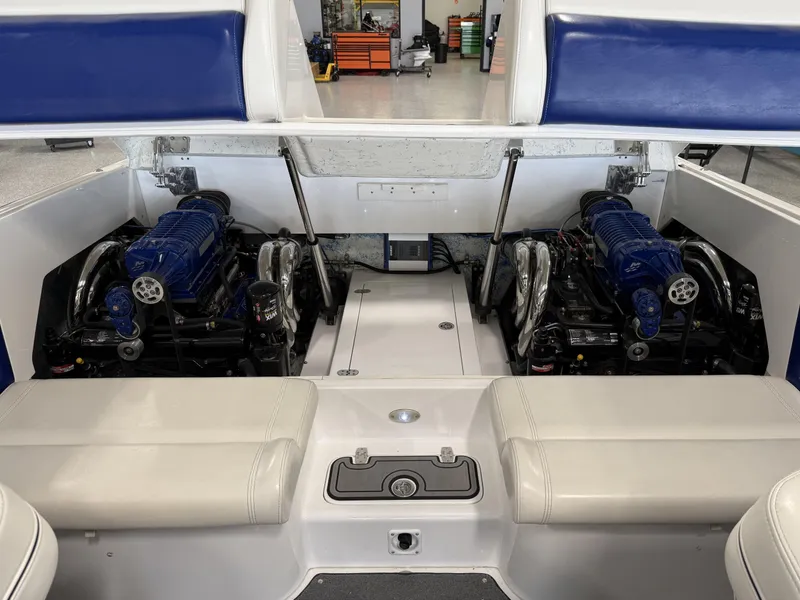 Slide: The Image of 2008 Magic 30' Sceptor boat engine compartment with dual blue engines. - 34