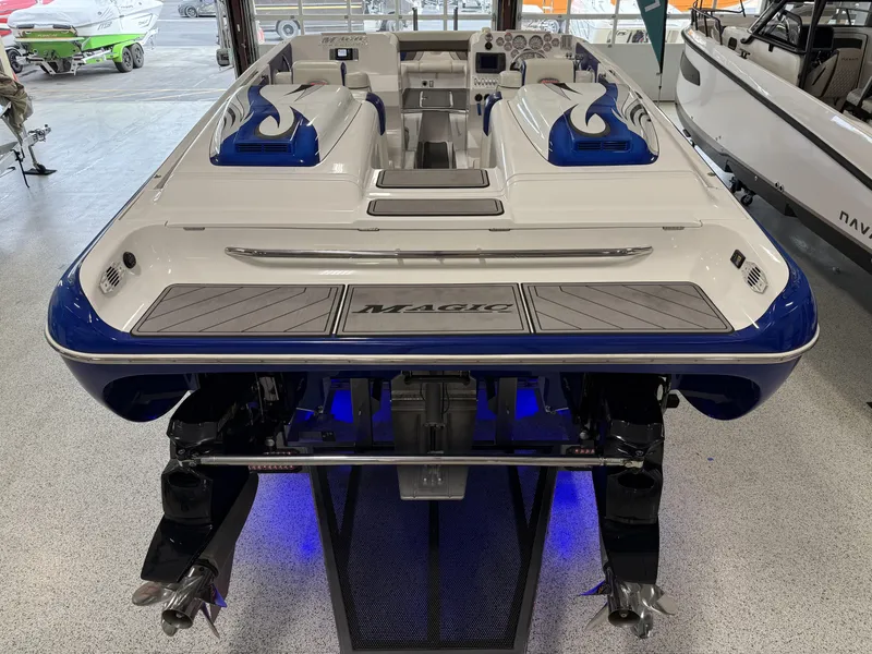 Slide: The Image of 2008 Magic 30' Sceptor boat with blue accents and dual engines in showroom. - 39