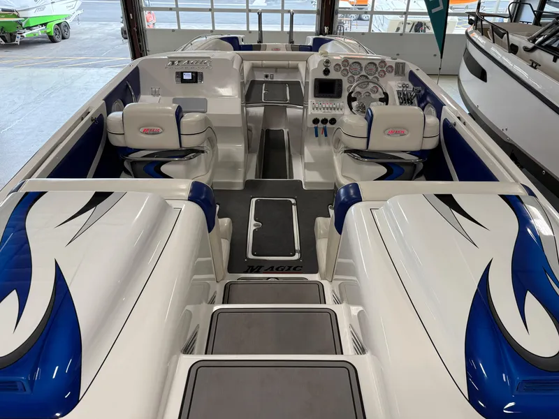 Slide: The Image of 2008 Magic 30' Sceptor boat interior with blue and white seating, sleek design, and control panel. - 41