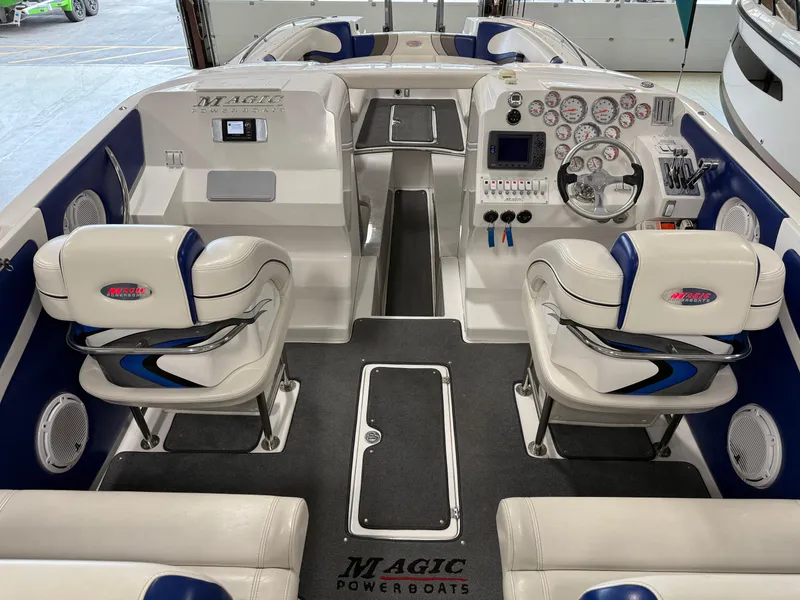 Slide: The Image of 2008 Magic 30' Sceptor boat interior with dual seats and modern dashboard controls. - 42