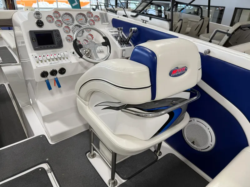 Slide: The Image of 2008 Magic 30' Sceptor boat cockpit with white and blue seating, steering wheel, and control panel. - 45