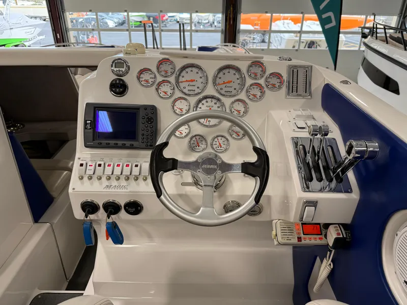 Slide: The Image of 2008 Magic 30' Sceptor boat dashboard with steering wheel, gauges, and controls. - 47