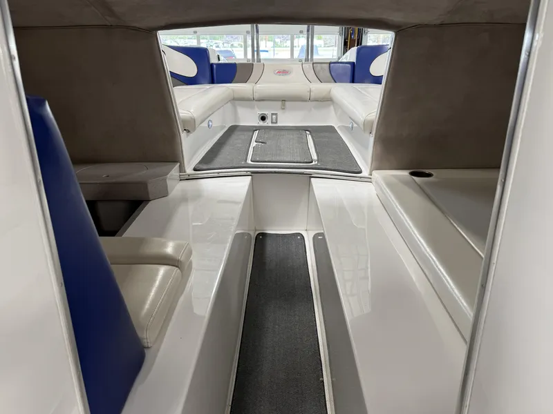 Slide: The Image of Interior of a 2008 Magic 30' Sceptor boat with blue and white seating. - 49
