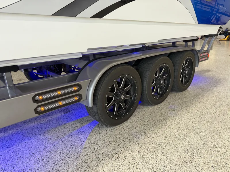 Slide: The Image of 2008 Magic 30' Sceptor boat trailer with triple axles and blue LED lighting. - 6