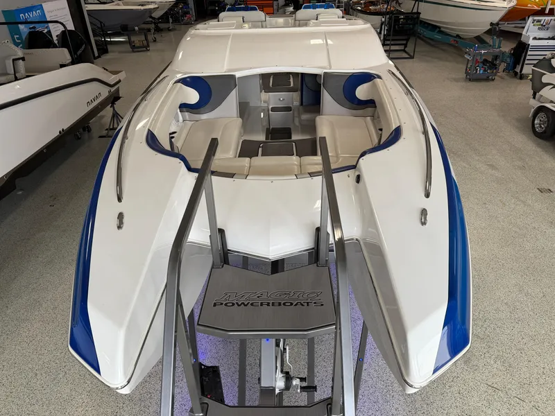 Slide: The Image of 2008 Magic 30' Sceptor powerboat with blue accents in a showroom. - 17