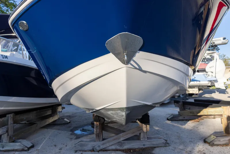 Slide: The Image of 2020 Chaparral 230 Suncoast boat on dry dock, blue and white hull. - 3