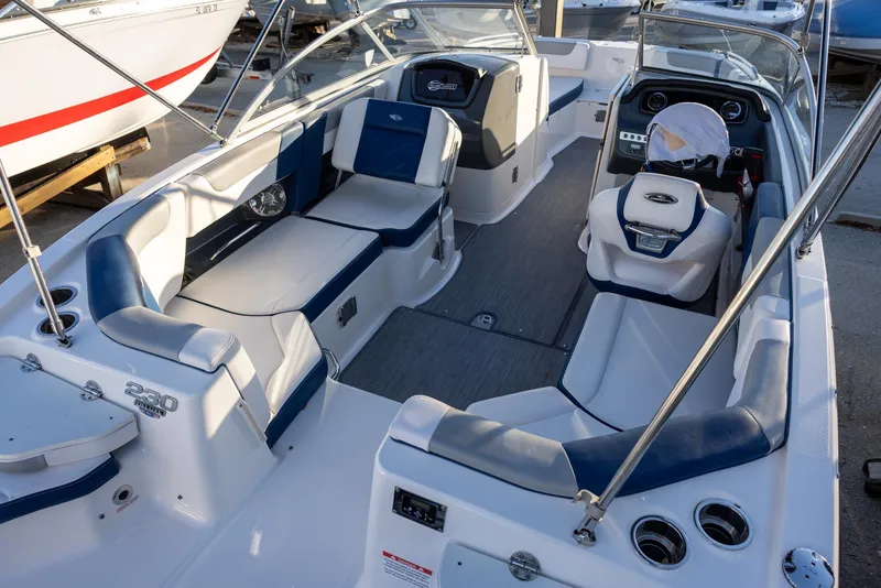 Slide: The Image of 2020 Chaparral 230 Suncoast boat interior with blue and white seating. - 6