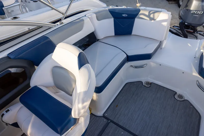 Slide: The Image of 2020 Chaparral 230 Suncoast boat interior with blue and white seating. - 7