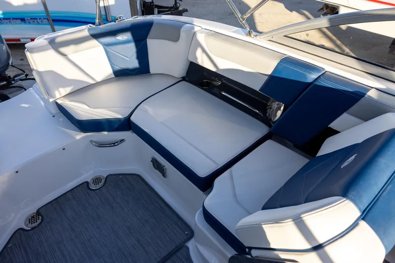 Slide: The Image of 2020 Chaparral 230 Suncoast boat interior with blue and white seating arrangement. - 8
