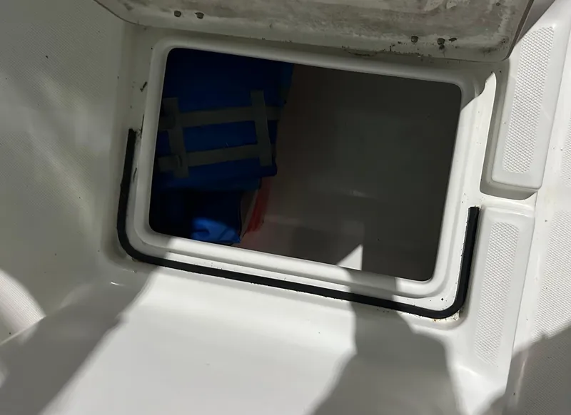 Slide: The Image of Open storage compartment on a 2005 Sea Fox 257 Walk Around boat. - 10