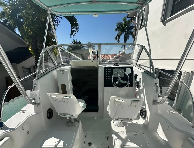 Slide: The Image of 2005 Sea Fox 257 Walk Around boat cockpit with dual seats and steering wheel. - 11