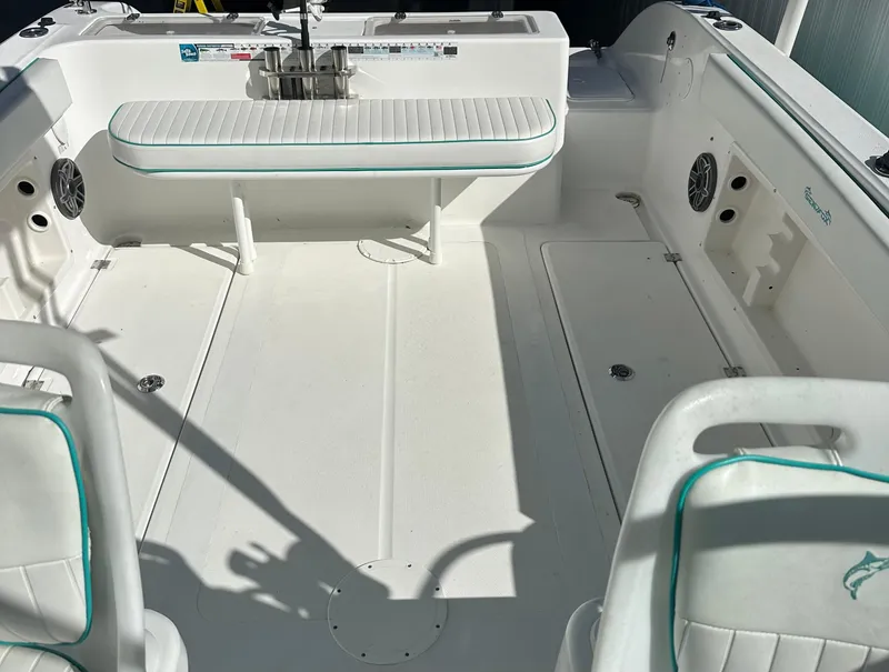 Slide: The Image of 2005 Sea Fox 257 Walk Around boat interior with seating and storage. - 12