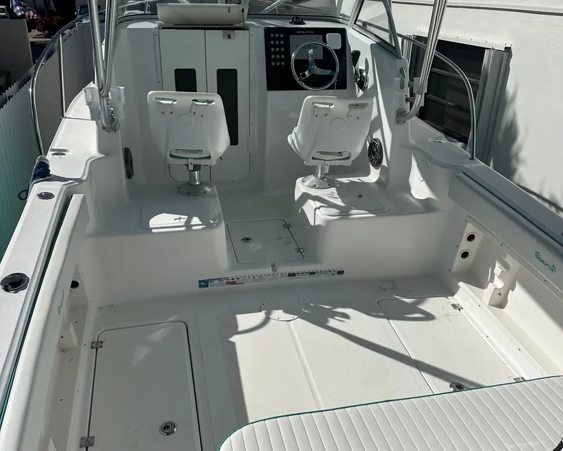 Slide: The Image of 2005 Sea Fox 257 Walk Around boat interior with dual seats and steering console. - 13