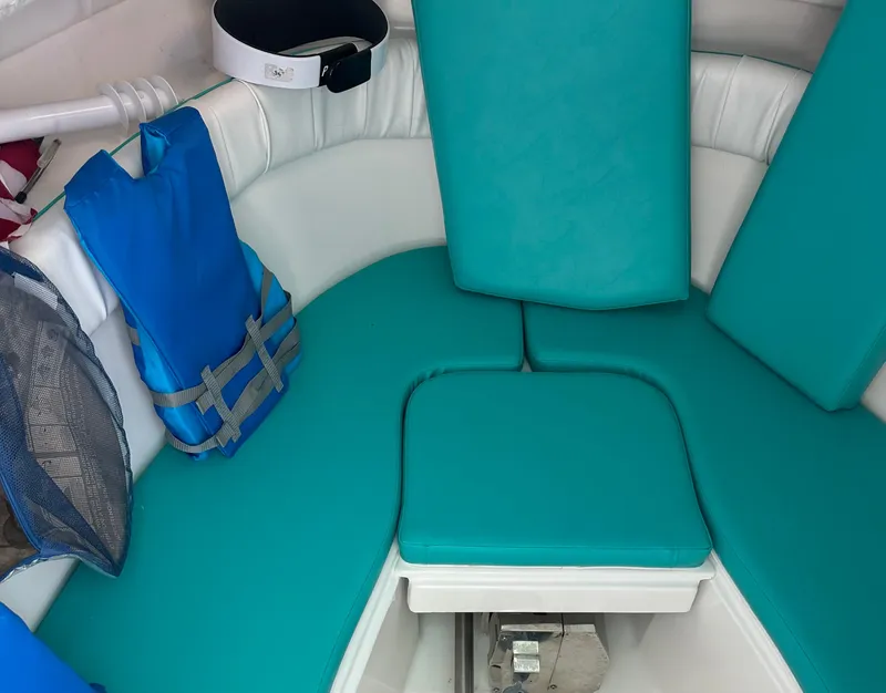 Slide: The Image of 2005 Sea Fox 257 Walk Around cabin with teal cushions and life jacket. - 15