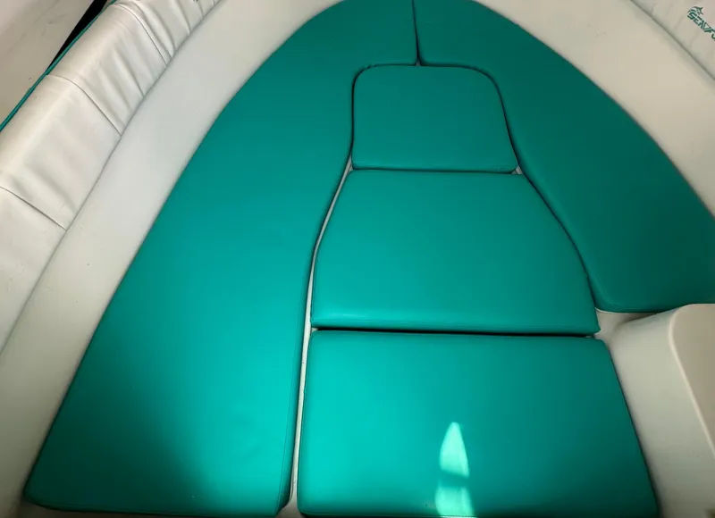 Slide: The Image of Teal cushioned seating in a 2005 Sea Fox 257 Walk Around boat interior. - 16