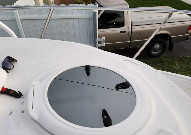 Slide: The Image of 2005 Sea Fox 257 Walk Around boat deck with hatch and sunglasses. - 19