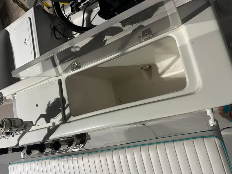 Slide: The Image of 2005 Sea Fox 257 Walk Around boat interior with open storage compartment. - 8