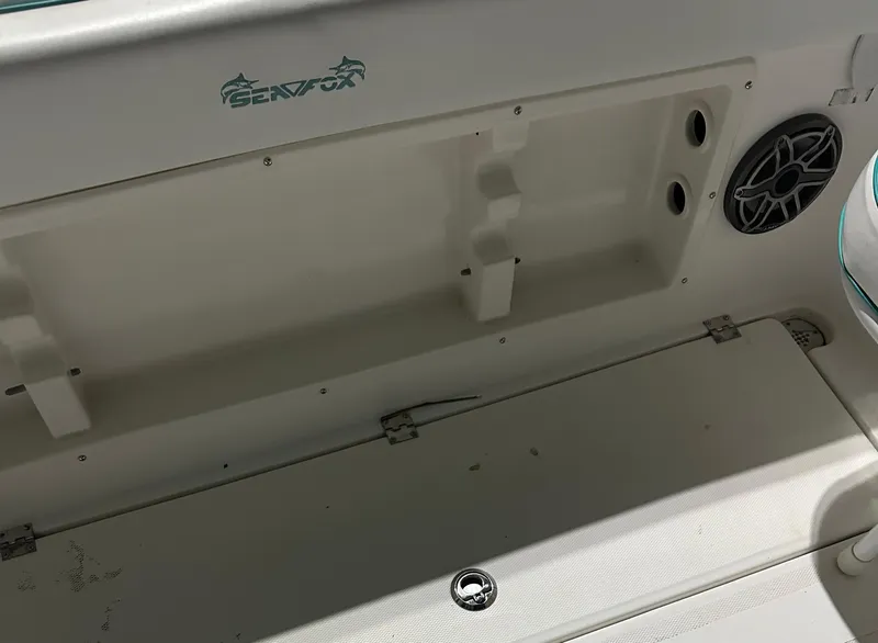 Slide: The Image of 2005 Sea Fox 257 Walk Around boat interior with storage compartment and speaker. - 9