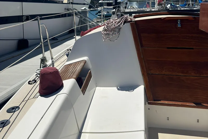 Slide: The Image of 1988 Catalina 30 sailboat cockpit with wooden accents and docked marina view. - 15