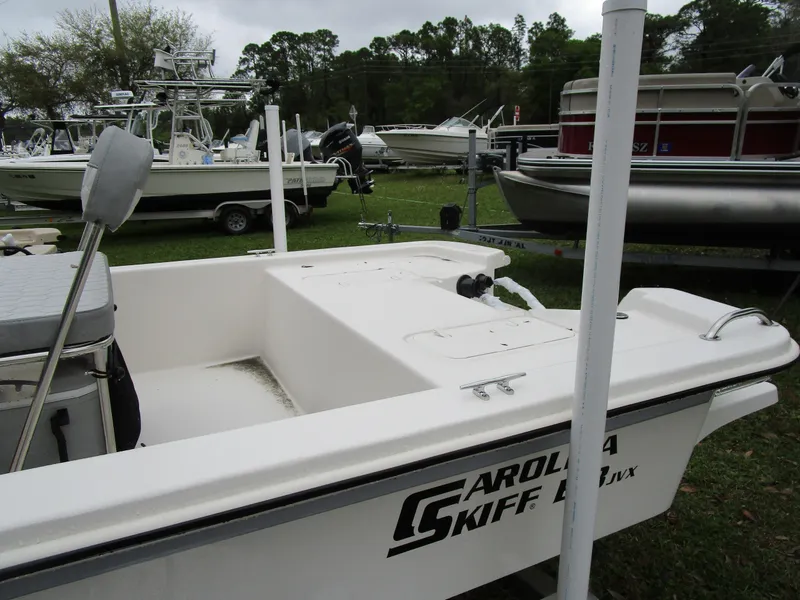 Slide: The Image of 2025 Carolina Skiff E Series E18 JVX CC boat displayed outdoors. - 3