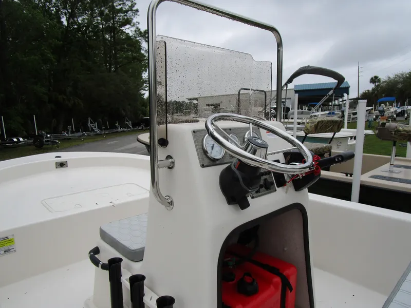 Slide: The Image of 2025 Carolina Skiff E Series E18 JVX CC boat console with steering wheel and controls. - 5