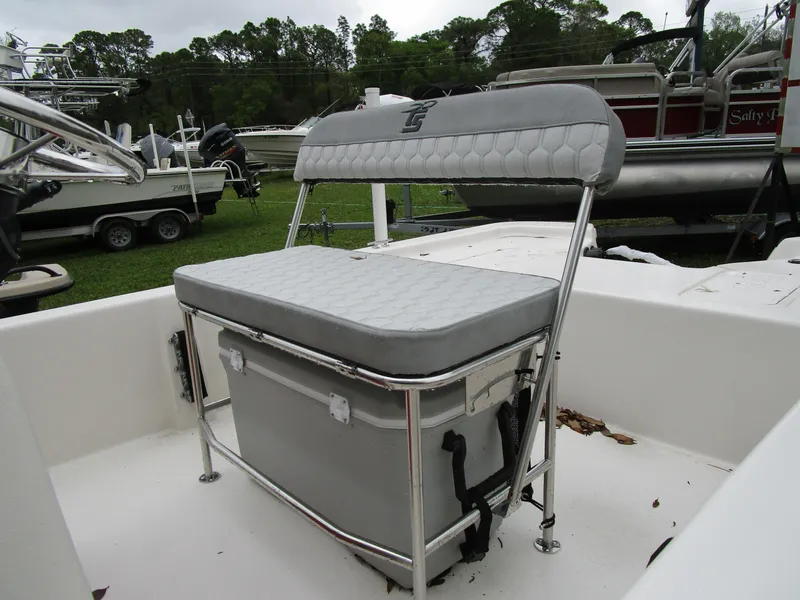 Slide: The Image of 2025 Carolina Skiff E Series E18 JVX CC boat seat with storage, outdoor setting. - 6