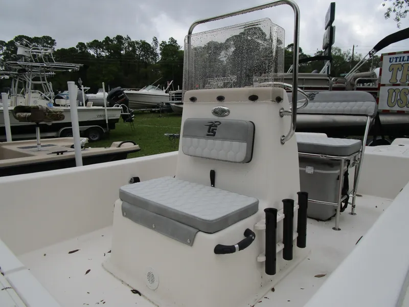 Slide: The Image of 2025 Carolina Skiff E Series E18 JVX CC boat interior with seating and rod holders. - 9