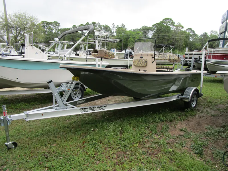 Slide: The Image of 2025 Carolina Skiff E Series E18 JVX CC on trailer, displayed outdoors. - 6