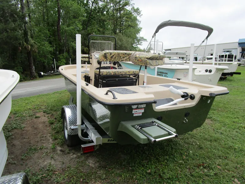 Slide: The Image of 2025 Carolina Skiff E Series E18 JVX CC boat on trailer, parked outdoors. - 7