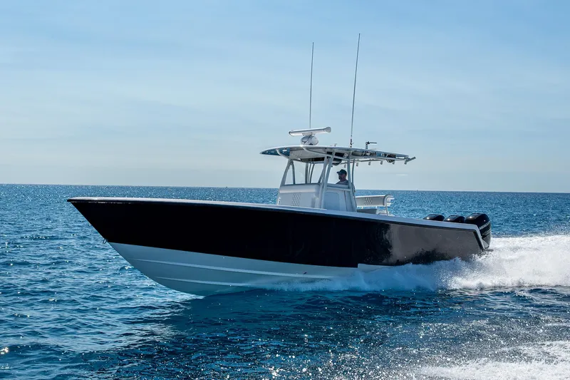 Slide: The Image of 2017 Contender 39 ST boat cruising on open water under clear skies. - 16