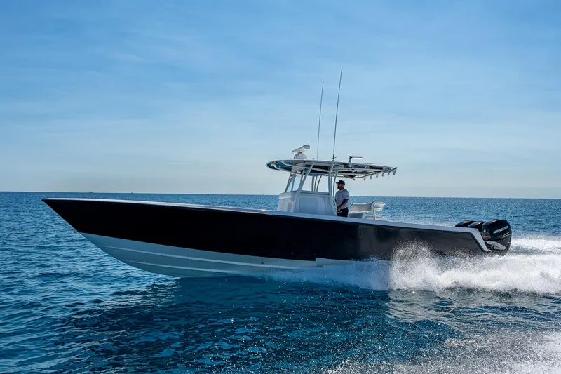 Slide: The Image of 2017 Contender 39 ST boat cruising on open water under clear blue sky. - 17