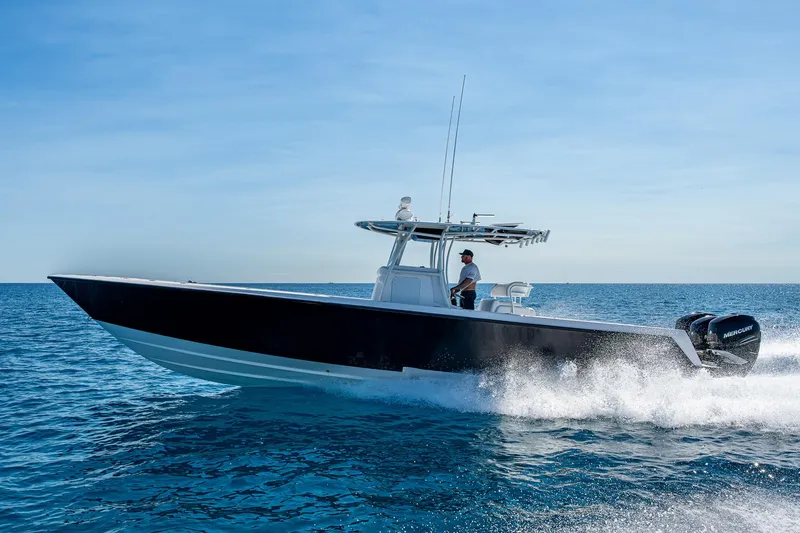 Slide: The Image of 2017 Contender 39 ST boat cruising on open water. - 18