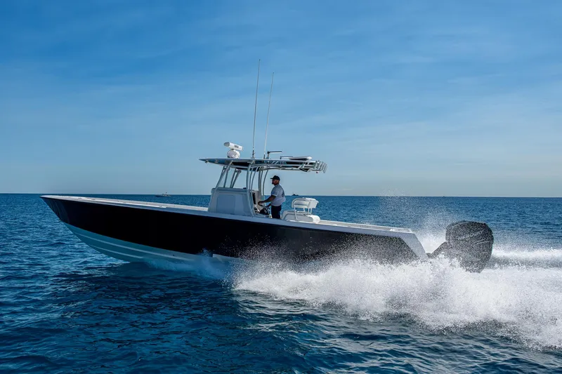 Slide: The Image of 2017 Contender 39 ST boat cruising on open ocean under clear blue sky. - 19