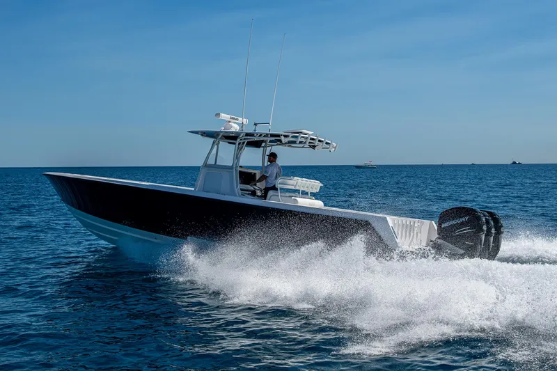 Slide: The Image of 2017 Contender 39 ST boat cruising on open water, creating a wake. - 20