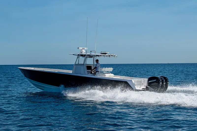 Slide: The Image of 2017 Contender 39 ST boat cruising on open water, side view. - 21