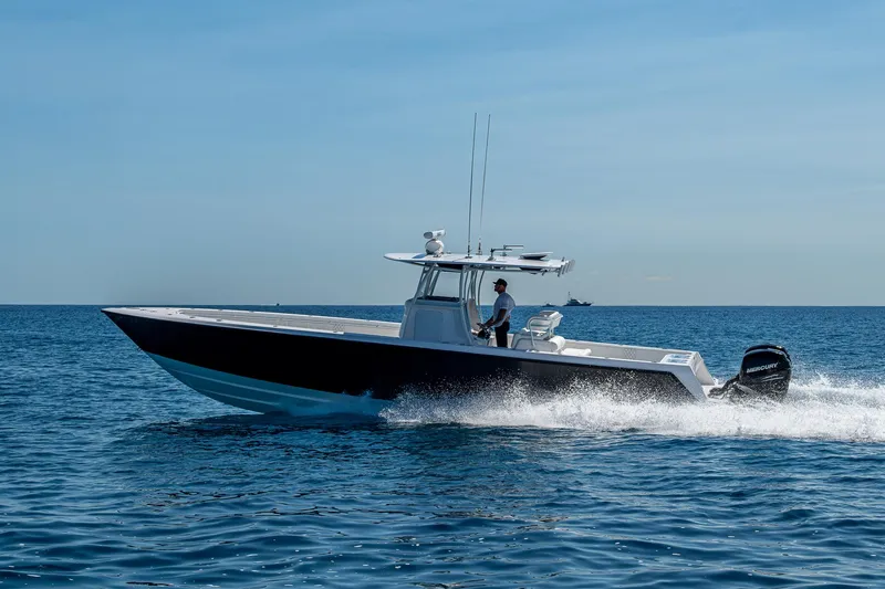 Slide: The Image of 2017 Contender 39 ST boat cruising on open water under clear blue sky. - 22